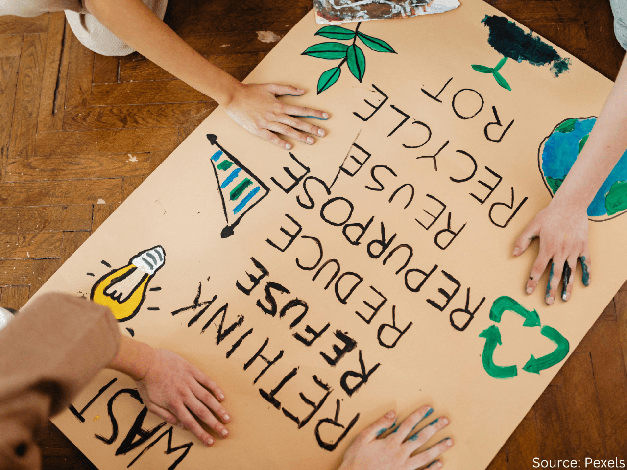 children drawing poster about reusing and recycling